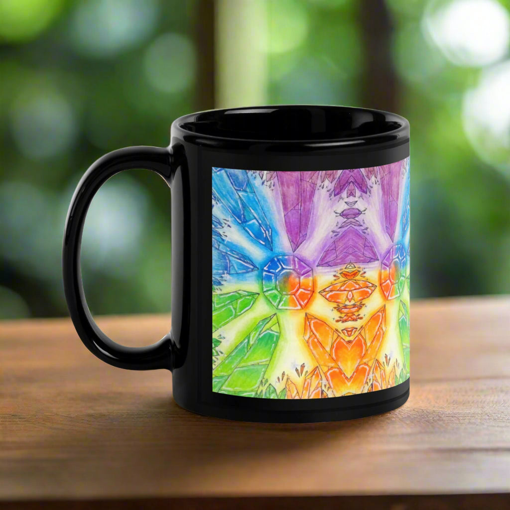 Black mug with a colorful tie-dye design on a white background